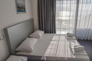 Postel nebo postele na pokoji v ubytování Whitehouse Apartments