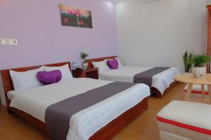 Postel nebo postele na pokoji v ubytování TH Quy Nhơn Hotel