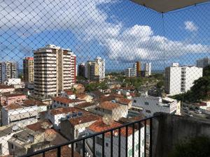 a view of a city with buildings and a fence at Apartamento amplo, arejado e confortável - Mínimo 3 noites in Ilhéus