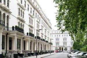 una strada di fronte a un edificio bianco di London House Hotel a Londra