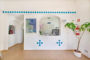 a white wall with a blue wall and a blue wall with a blue wall at Hotel Mare Blue in Olbia