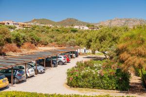 a row of cars parked in a parking lot at Hotel Mare Blue in Olbia