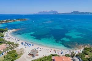an aerial view of a beach with people in the water at Hotel Mare Blue in Olbia