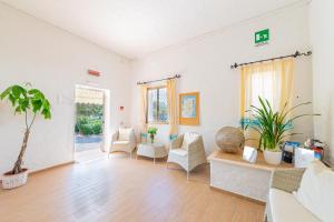 a living room with a couch and chairs at Hotel Mare Blue in Olbia