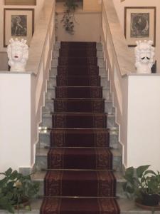 a row of stairs leading up to a large room at Al Piazza Marina Palace in Palermo