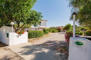 a street light next to a driveway with a house at Hotel Mare Blue in Olbia