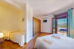 a hotel room with two beds and a balcony at Hotel Mare Blue in Olbia