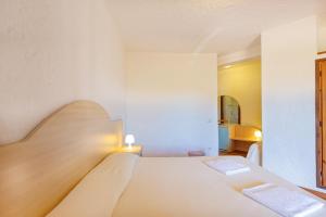 a bedroom with a large white bed in a room at Hotel Mare Blue in Olbia