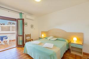 a bedroom with a bed with two towels on it at Hotel Mare Blue in Olbia