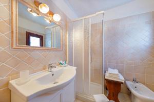 a bathroom with a sink and a shower at Hotel Mare Blue in Olbia