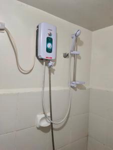 a shower in a bathroom with a soap dispenser at Mhavic family room ,group friend good for 6 guest in Manila