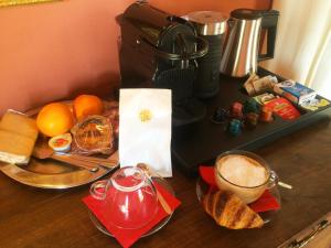 a table with a cup of coffee and a plate of bread at Villa Il Colle B&B in Bagno a Ripoli
