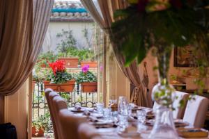 a table with chairs and a table with glasses on it at Corte Rossetti Le Dimore Luxury B&B in Vasto