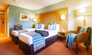 A bed or beds in a room at Lanhydrock Hotel & Golf Club