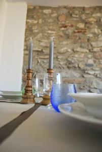 a table with two candles and a plate of food at Cà de l'Adamo - Rebomaholidays in Olzano
