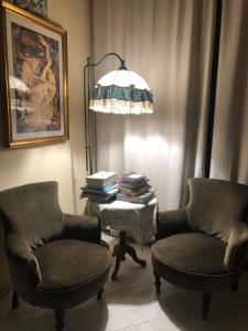 a living room with a chair and a lamp at Al Piazza Marina Palace in Palermo
