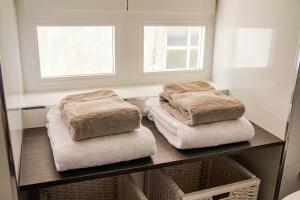 dos toallas sentadas en un estante en un baño en BF Suites & Apartments en Oporto