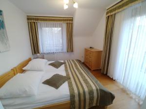 a bedroom with a large bed and a window at APARTAMENTY u KOWALA in Szczawnica