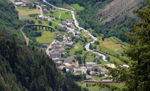an aerial view of a village in the mountains at Ca' del Borgo, Rooms & Suites in Poschiavo