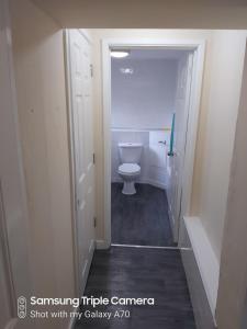 a bathroom with a white toilet in a hallway at Castle view in Cardiff