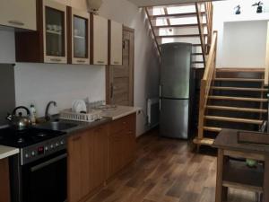 a kitchen with a stove and a refrigerator at Kwatera Pod Bukowa Gora in Zwierzyniec