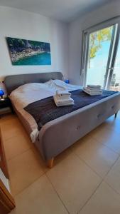 Cama en habitación con ventana grande en Casa Calida 2 Jardin 11, en Alhama de Murcia