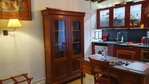 a kitchen with a wooden cabinet and a table at Bernardo 42 Galande in Paris