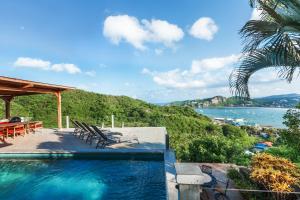 a swimming pool with a view of the water at Casa ChaChaCha in San Juan del Sur