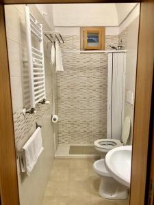 a bathroom with a toilet and a sink at Al Civico 3 CENTRO in Polignano a Mare