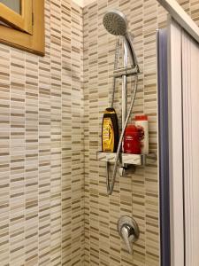 a shower with a shower head in a bathroom at Al Civico 3 CENTRO in Polignano a Mare