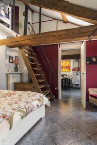 a bedroom with a loft bed and a staircase at B&B MI Casa Tu Casa in Pavia