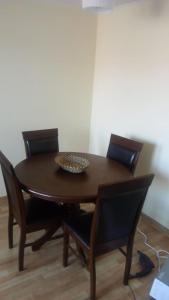 a wooden table with chairs and a bowl on top at Atacama Valley 5 in Copiapó