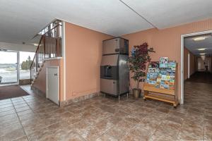 a kitchen with a refrigerator in a room at Americas Best Value Inn Ashtabula/Austinburg in Austinburg