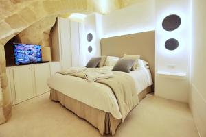 Letto o letti in una camera di Anima Pietra Luxury Suite