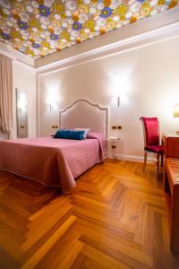 Postel nebo postele na pokoji v ubytování Boutique Hotel Puccini
