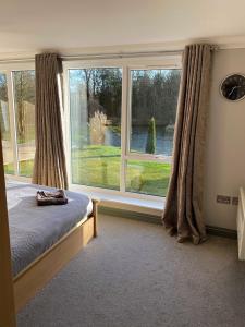 a bedroom with a bed and a large window at Everglades in Denver