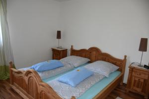 a bedroom with a bed with blue pillows on it at Fewo-Bernkastel-Kues in Bernkastel-Kues
