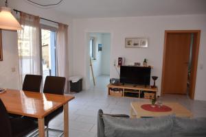 a living room with a table and a television at Fewo-Bernkastel-Kues in Bernkastel-Kues