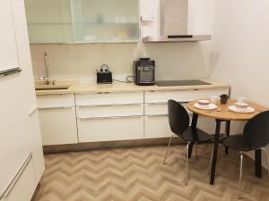 a small kitchen with a table and two chairs at Freinest Wien in Vienna