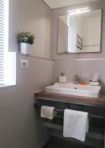 a bathroom with a sink and a mirror at H5-5H Luxury Room in Maranello