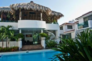 a villa with a swimming pool and a resort at Villas Maria Isabel in Santa Cruz Huatulco