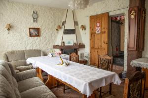 a living room with a table with a white table cloth at Zajazd U Julii in Miastko