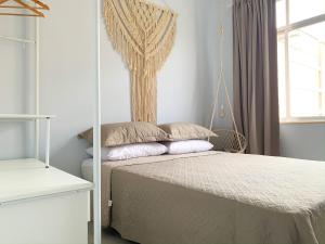 a bedroom with a bed and a window at Conforto em Copacabana- 100m da praia - BR1033 in Rio de Janeiro