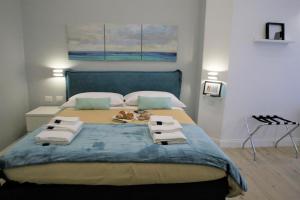 ein Schlafzimmer mit einem großen Bett mit Handtüchern darauf in der Unterkunft Porta San Gennaro in Neapel