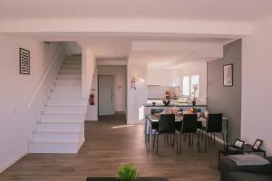 a living room with a staircase and a table and chairs at Marlin House II in Ferrel