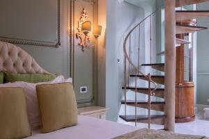 a bedroom with a bed and a spiral staircase at Villa Palma Boutique Hotel in Panama City