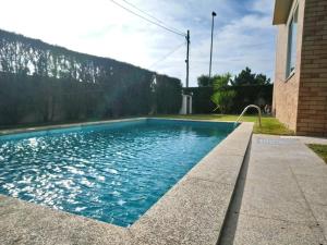 a swimming pool next to a house at Beach House - Between Porto and Viana do Castelo in Esposende