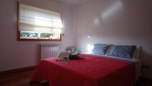 a bedroom with a bed with a red blanket and a window at Beach House - Between Porto and Viana do Castelo in Esposende +44 photos