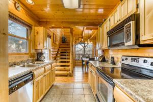 a large kitchen with wooden cabinets and appliances at Nature's Paradise in Pigeon Forge +38 photos