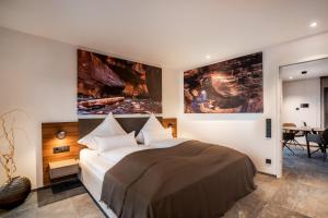 a bedroom with a bed and a large painting on the wall at PRIMERA Apartments in Singen